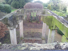 The restored cast iron lion's head mask refixed above the pool