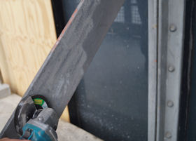 Loose paint layers removed from ironwork back to a sound surface