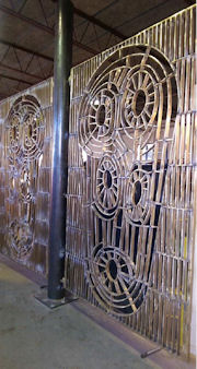 Patinated bronze gate leaf finished with a coat of wax
