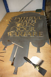 Re-gilded memorial plaque and serpent at the centre of the overthrow
