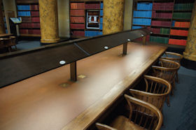 Replica brass and aluminium lighting canopies over the Manchester Central Library reading room desks